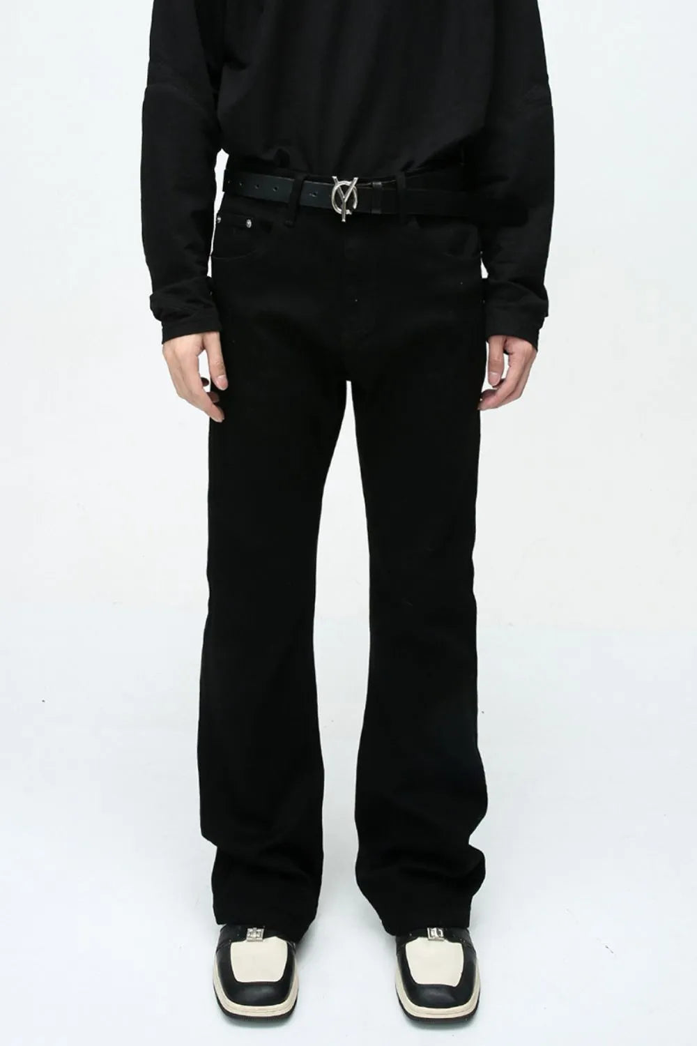 Flared leg black denim jeans with a casual 70s style.