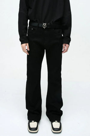 Flared leg black denim jeans with a casual 70s style.