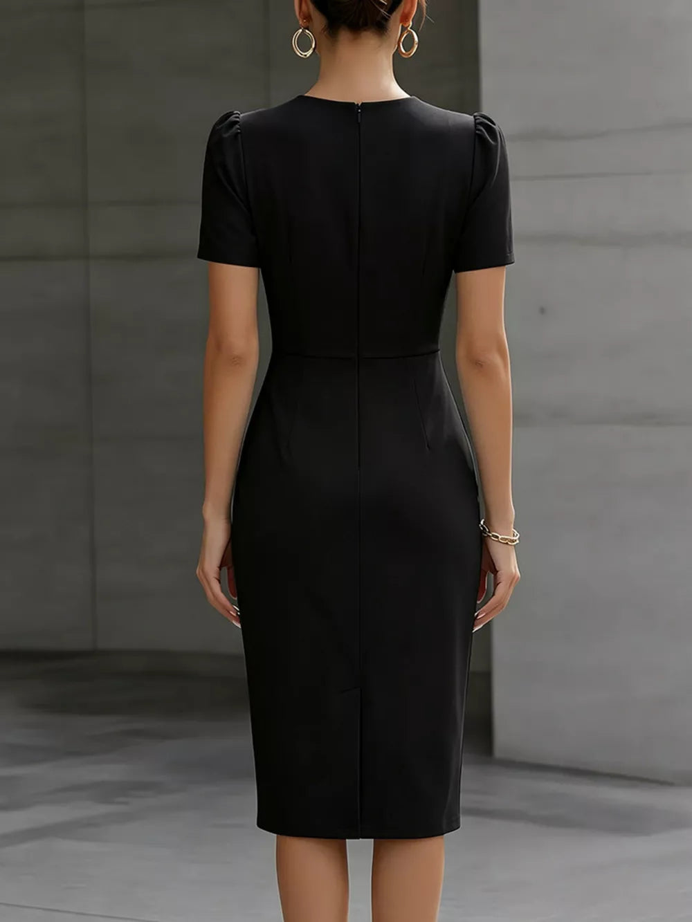Black midi dress with ruched waist, short sleeves, and a back zipper.