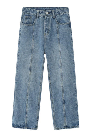 Medium wash denim jeans with vertical seam detail and straight leg cut.