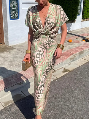 Twist-front animal print maxi dress with deep V-neck and short sleeves.