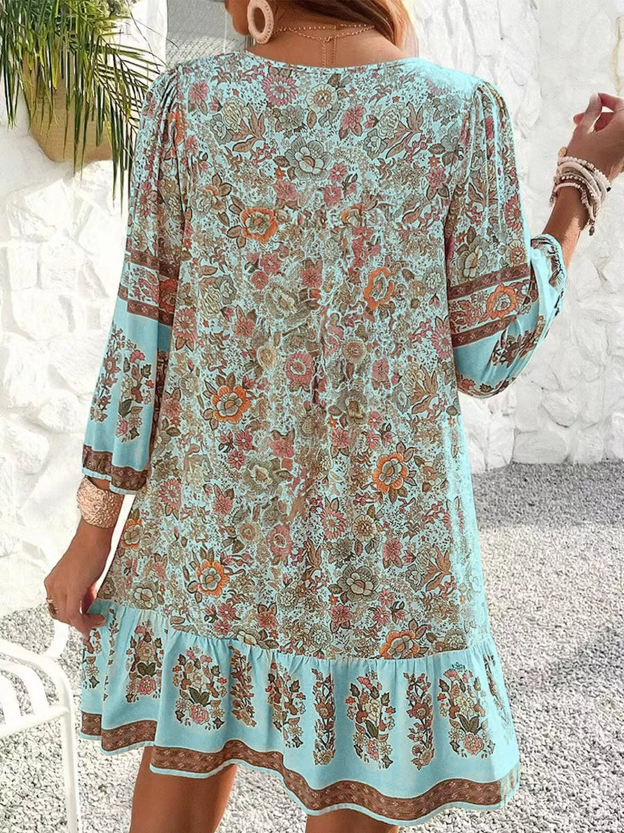 Light Blue floral print mini dress with tiered ruffle hem and tassel ties.