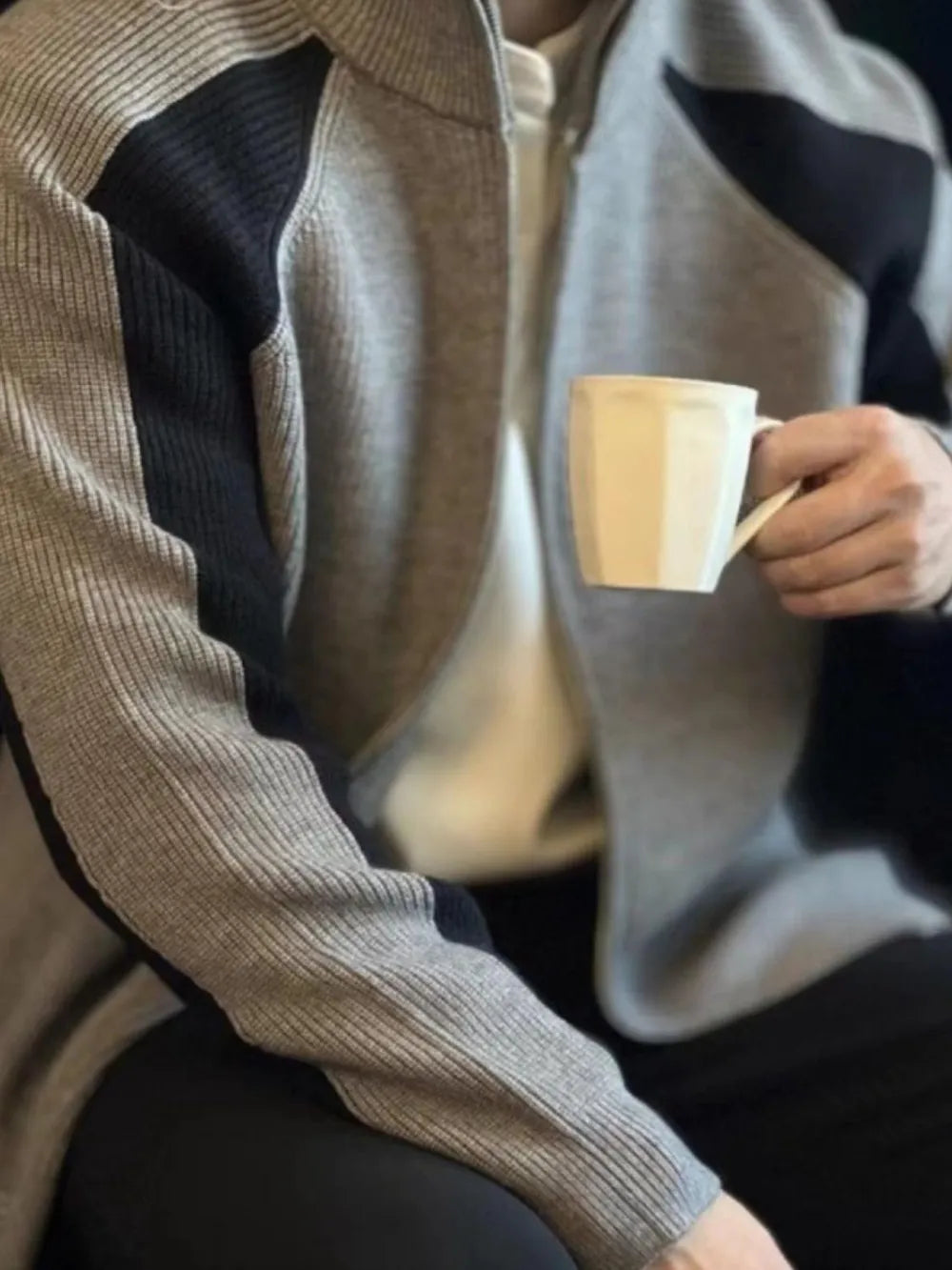 Gray ribbed zip-up track jacket with black contrast panels and a stand-up collar.