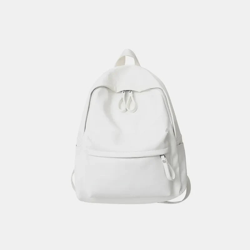 White leather minimalist backpack with front zip pocket and dual top zippers.