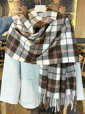 Plaid fringe scarf in brown, white, and red, draped over a light grey coat.