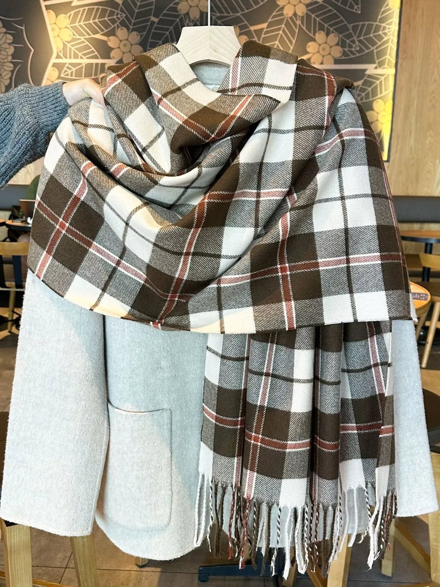 Plaid fringe scarf in brown, white, and red, draped over a light grey coat.