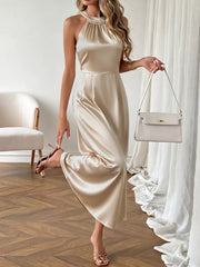 Champagne satin midi dress with pearl neckline, halter style, A-line cut.