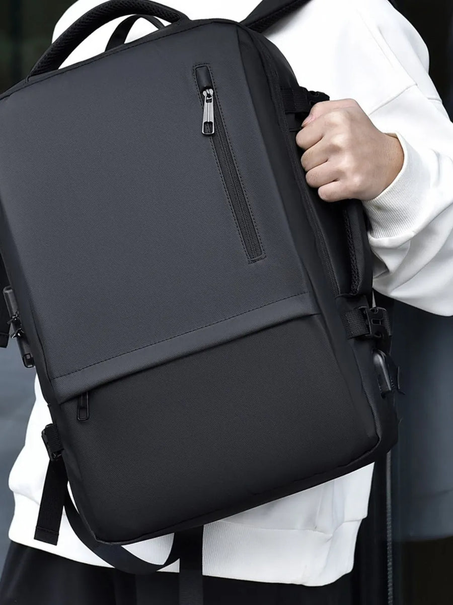 Black convertible commuter backpack with zippered pockets and padded straps.