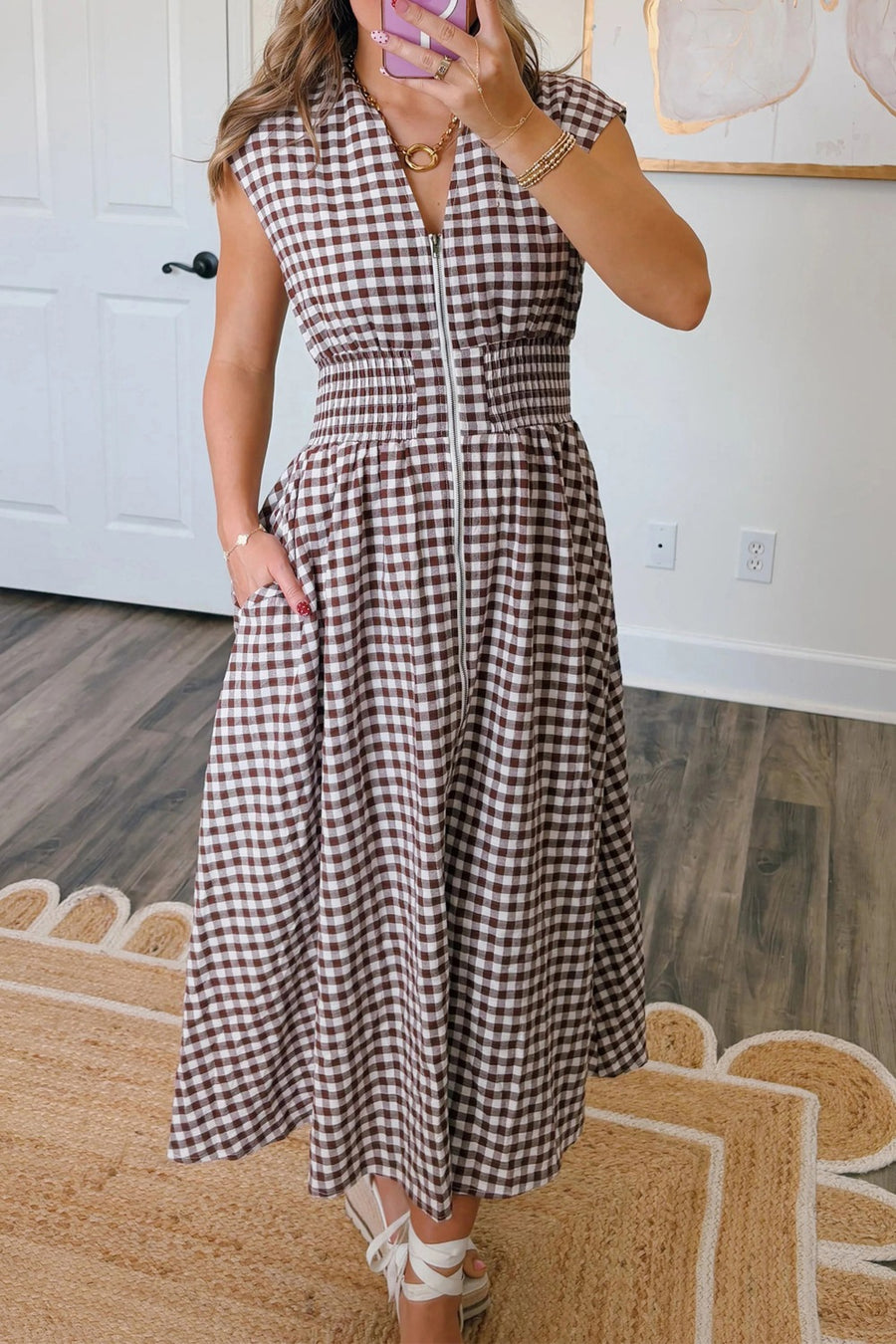Gingham zip-front midi dress in taupe with smocked waist and pockets.