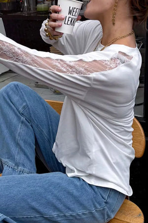 White long sleeve shirt with delicate lace paneling on the sleeves and crew neckline.