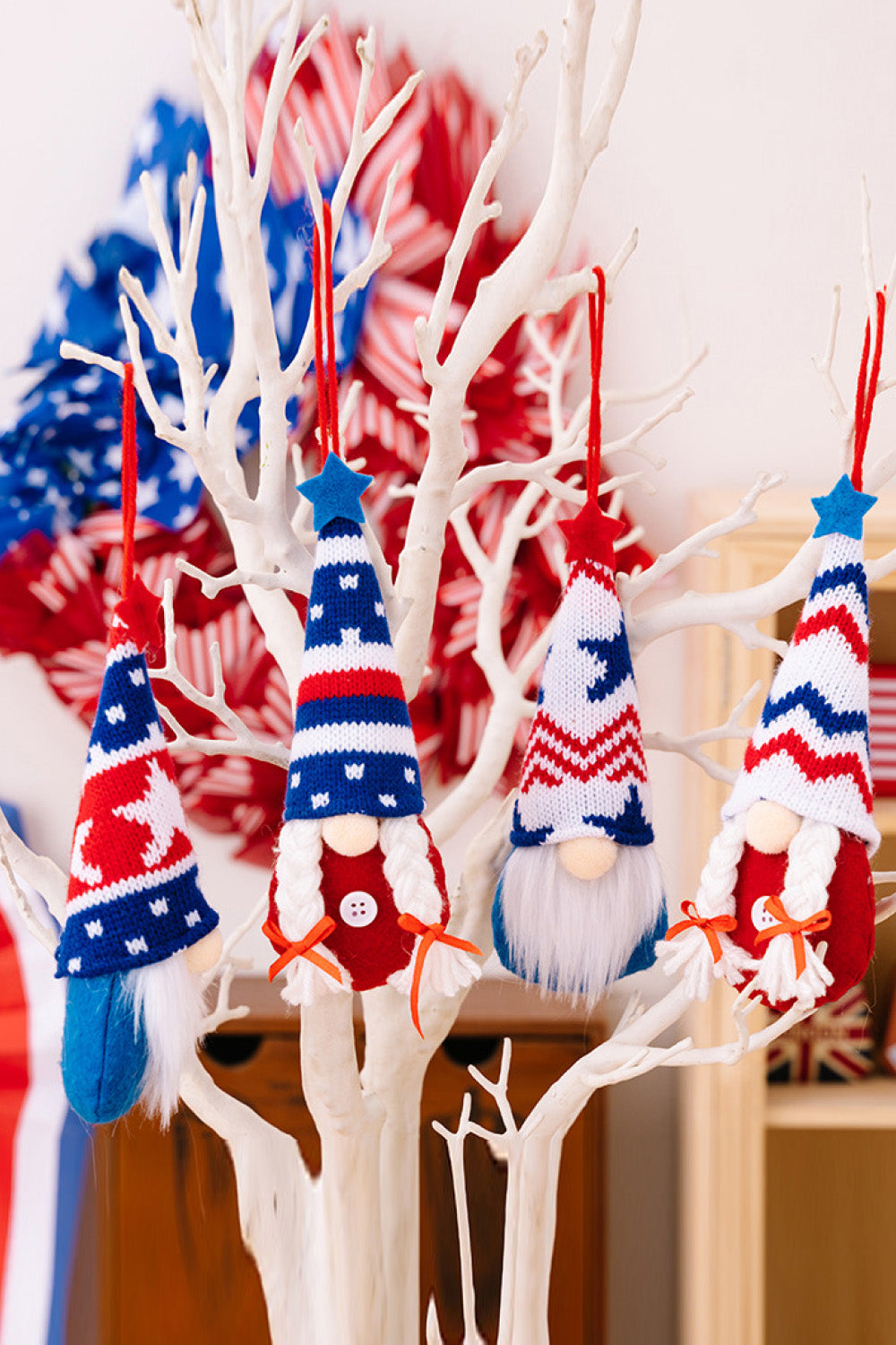 Patriotic knit gnome ornaments in red, white, and blue with stars and stripes patterns.