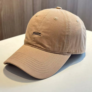 Khaki baseball cap with embroidered "Hello" detail