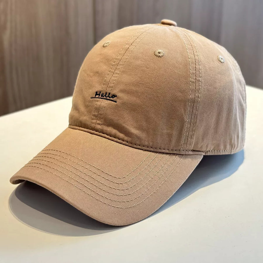 Khaki baseball cap with embroidered "Hello" detail