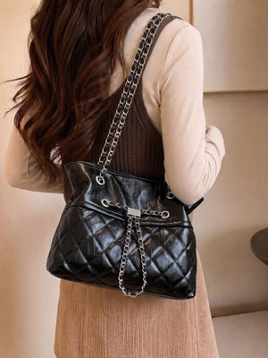 black handbag with magnetic snap and quilted