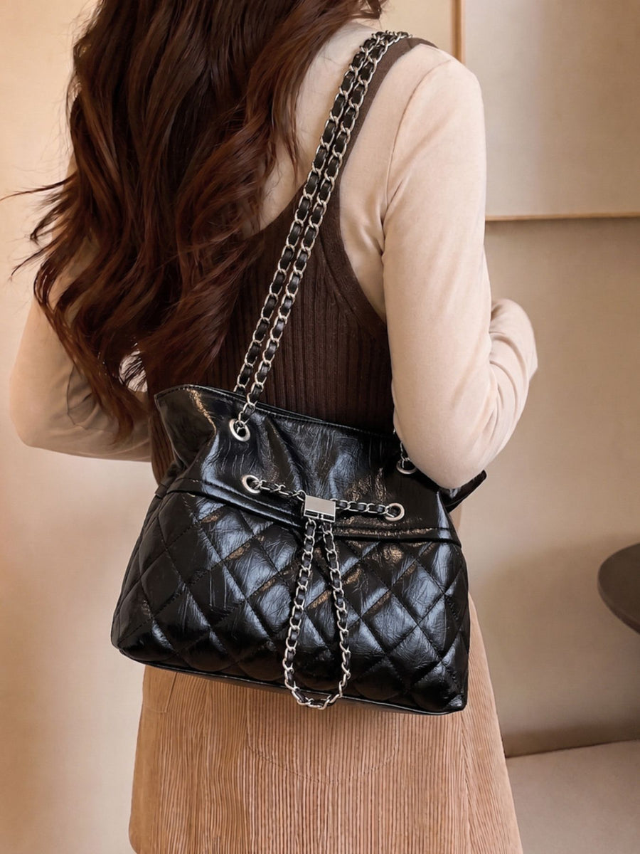 black handbag with magnetic snap and quilted