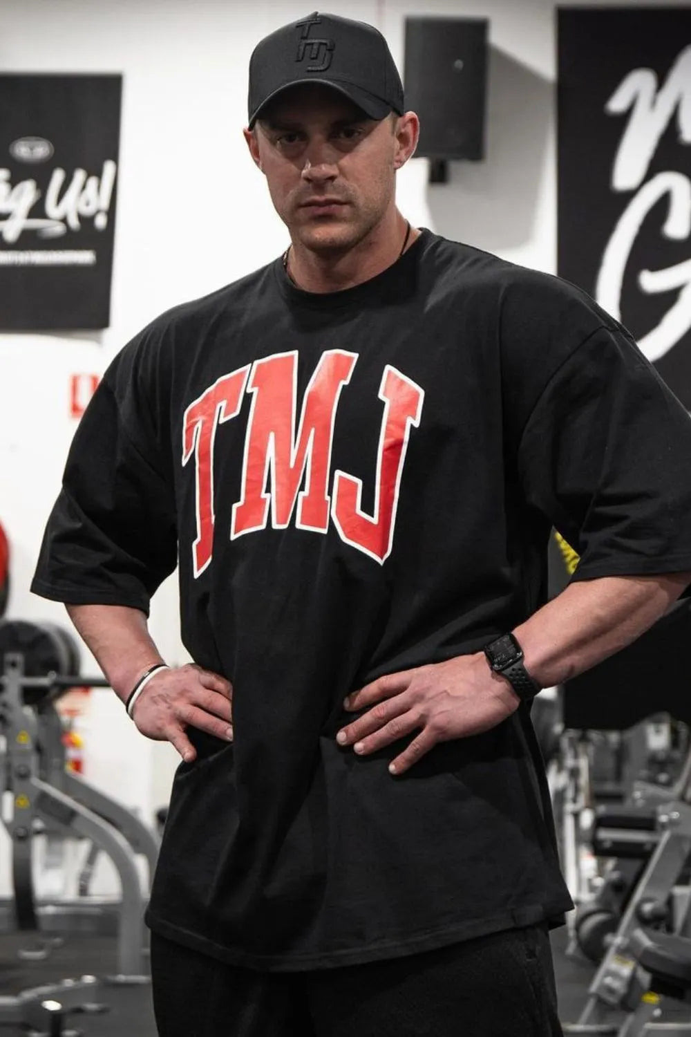 Black oversized graphic tee with red TMJ lettering and athletic appeal