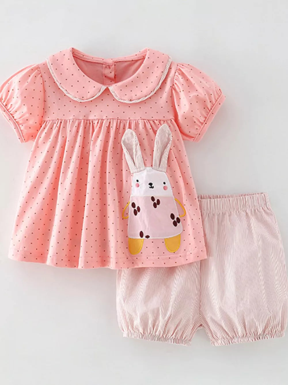 Pink polka dot cotton toddler set with bunny applique and striped bubble shorts.