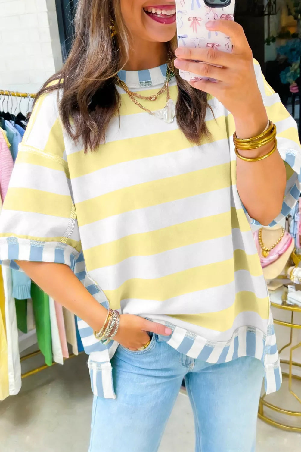 Striped t-shirt with yellow and white horizontal stripes and blue and white vertical striped cuffs.