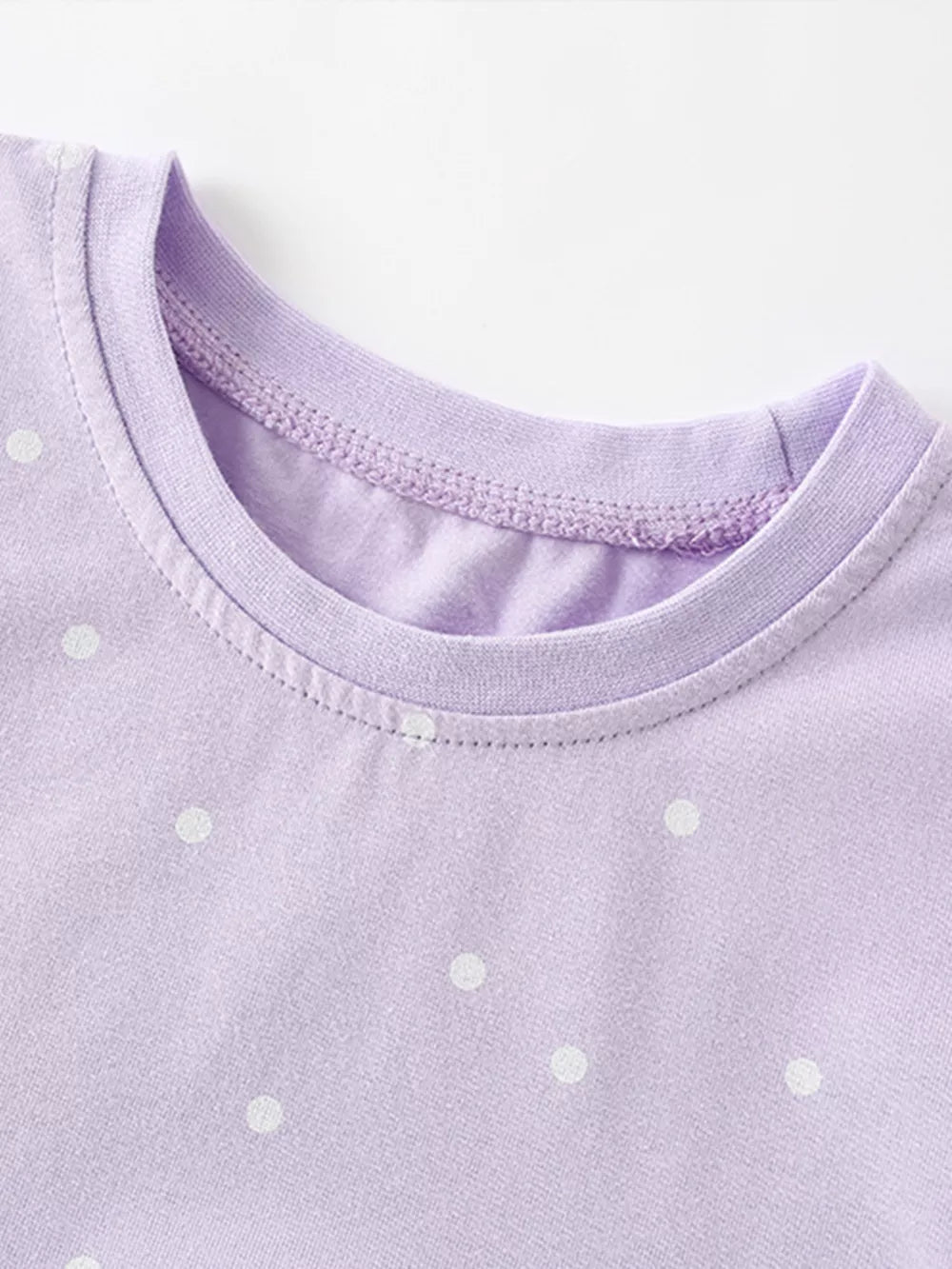 Lavender cotton baby dress with white polka dots and crew neck detail.