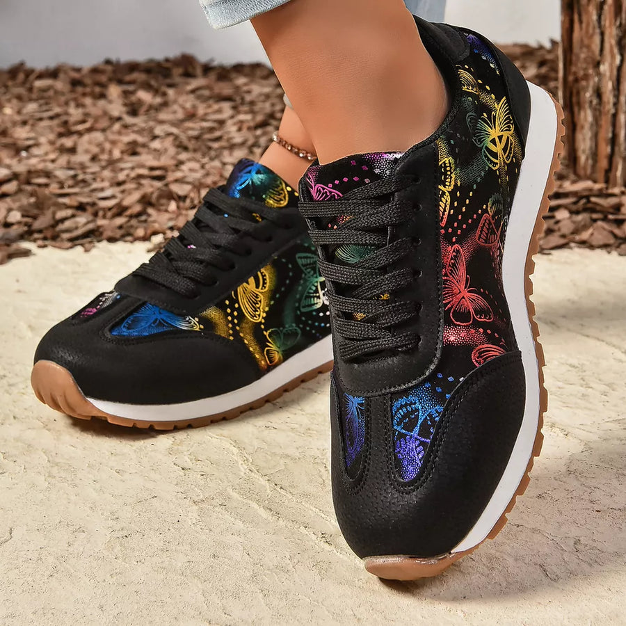Black casual sneakers with rainbow butterfly print and lace-up closure.