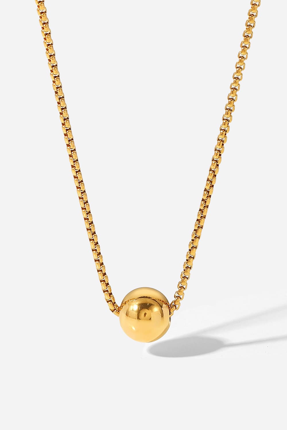 Gold orb pendant necklace with a box chain, casual women's jewelry.