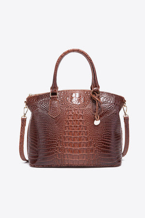 Brown crocodile embossed satchel with shoulder strap and top handles