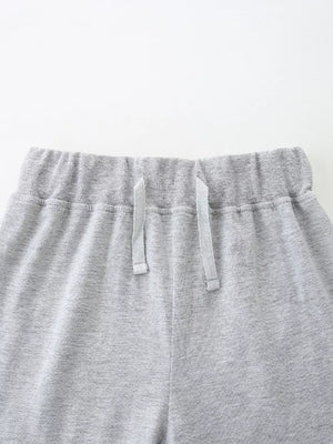 Grey cotton blend baby shorts with elastic waistband and drawstring.