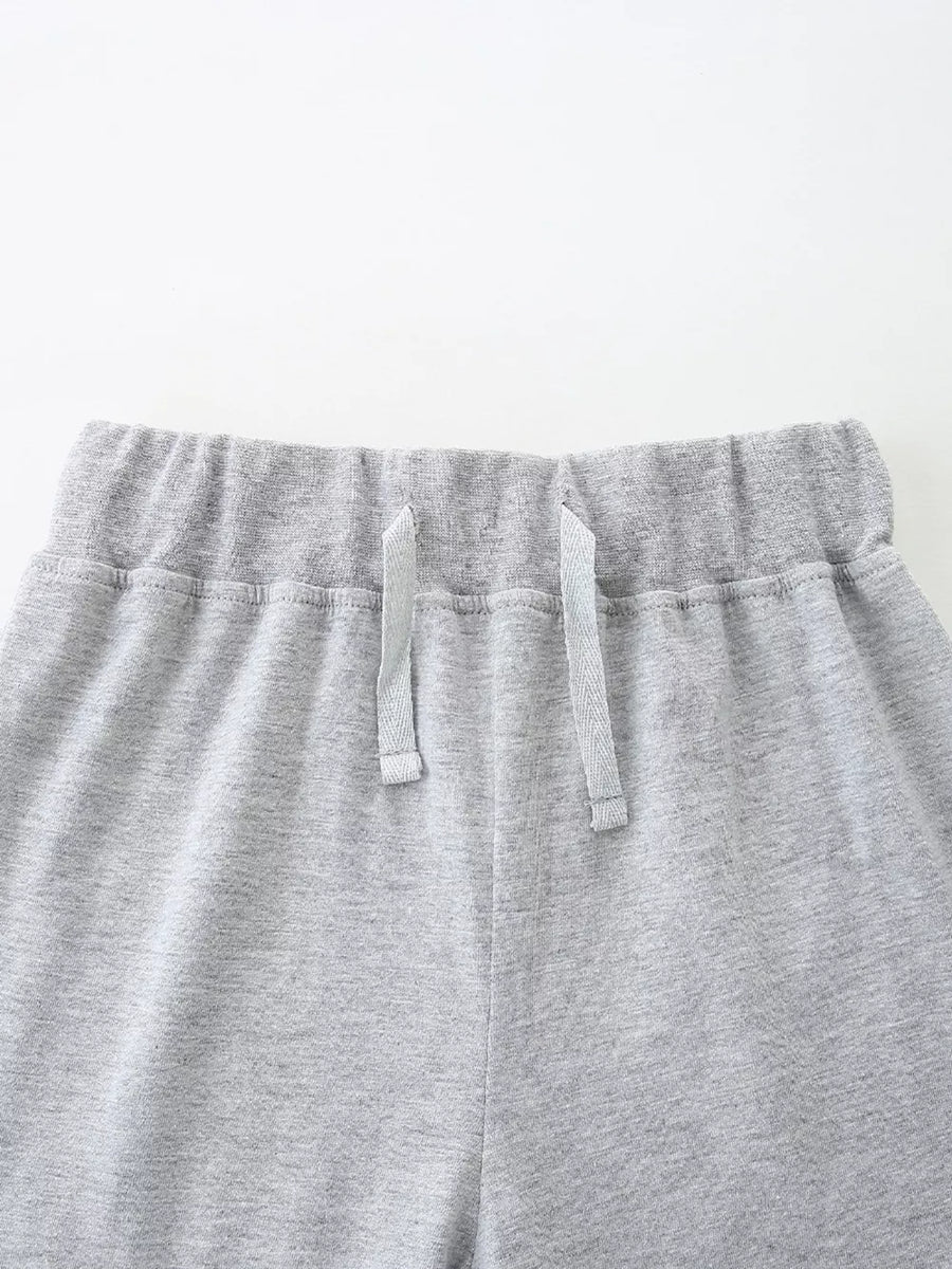Grey cotton blend baby shorts with elastic waistband and drawstring.