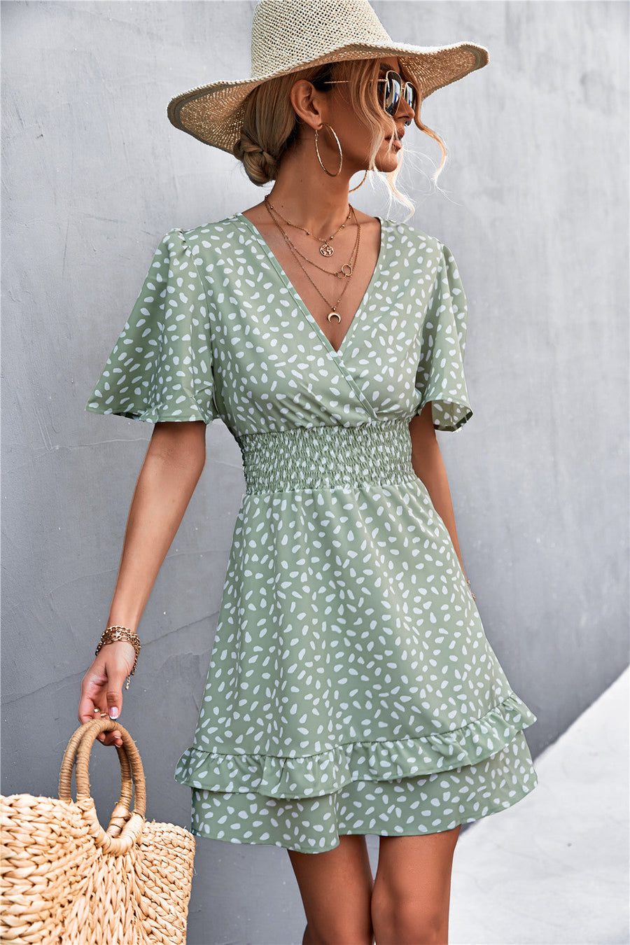 Gum Leaf smocked waist mini dress with flutter sleeves and ruffle hem, featuring a white speckle print.