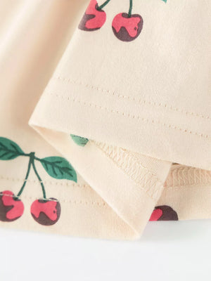 Children's ivory cherry print dress with ruffle neck detail.