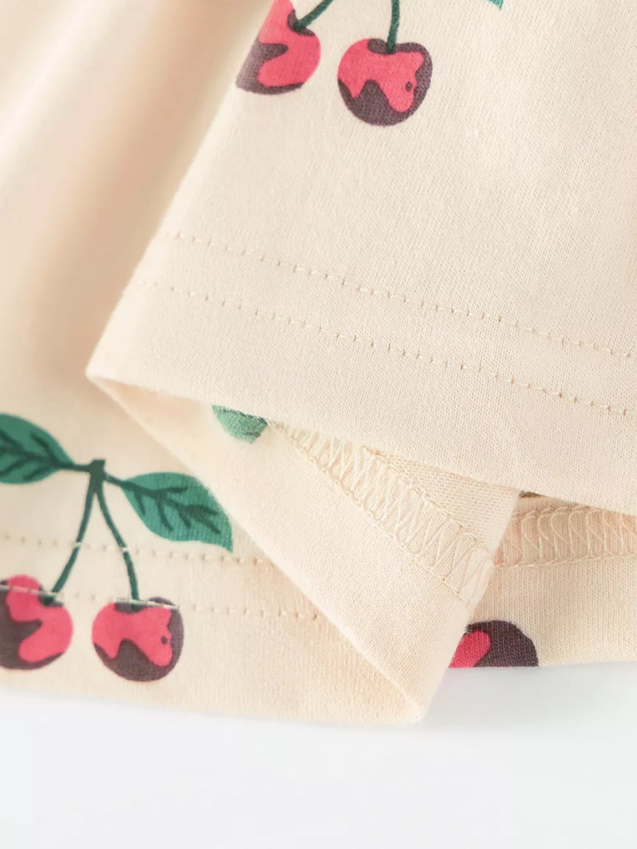 Children's ivory cherry print dress with ruffle neck detail.
