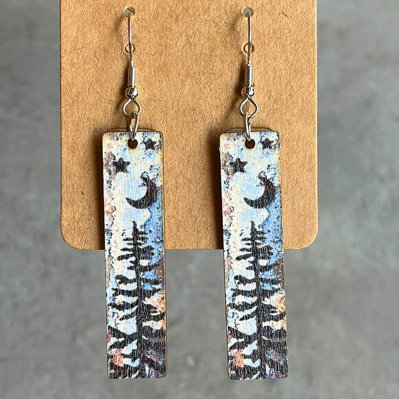 Painted landscape dangle earrings with moon, stars, and trees.