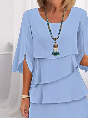 Light blue ruffled layered dress with flutter sleeves and a scoop neckline.