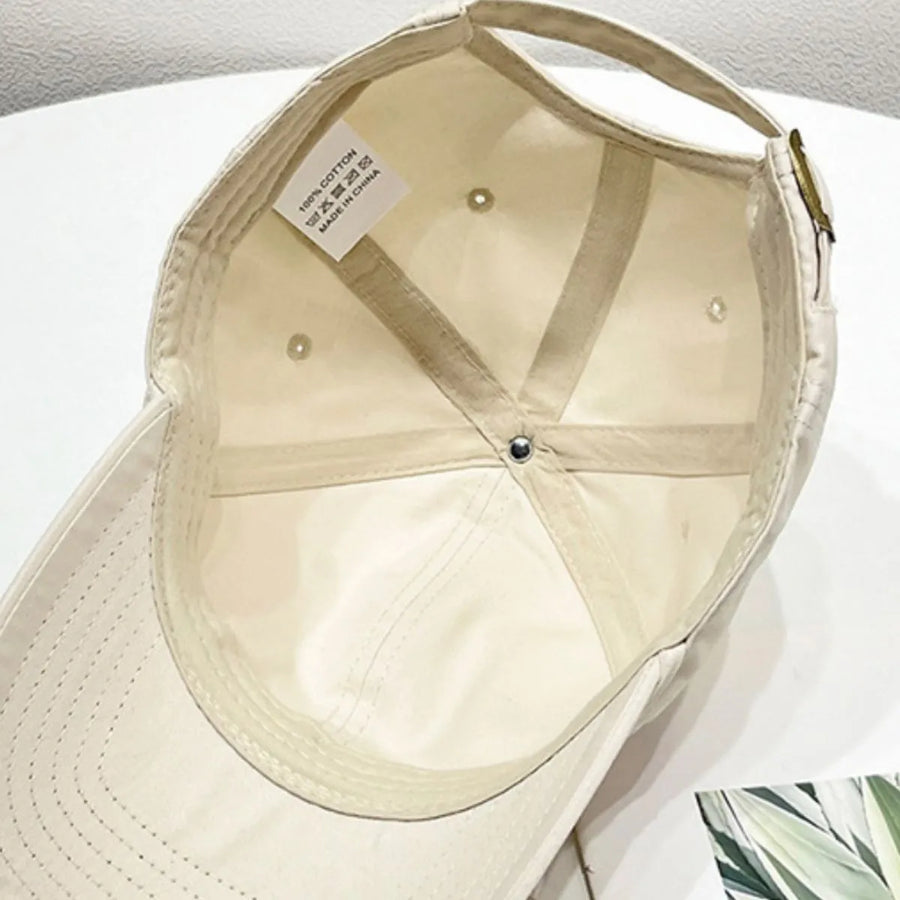 Cream baseball cap interior with 100% cotton tag and adjustable strap