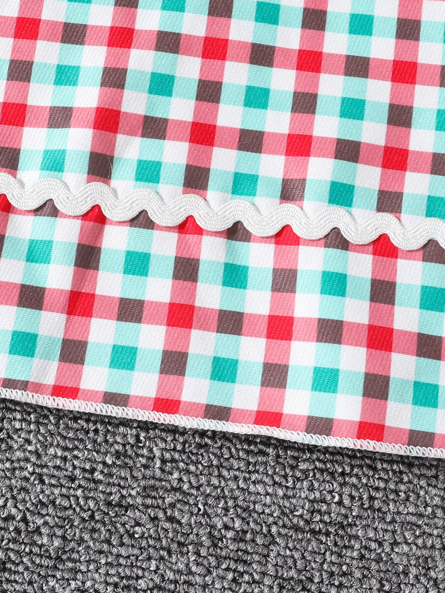 Festive plaid dress for little girls in multicolor gingham with white ric rac trim.