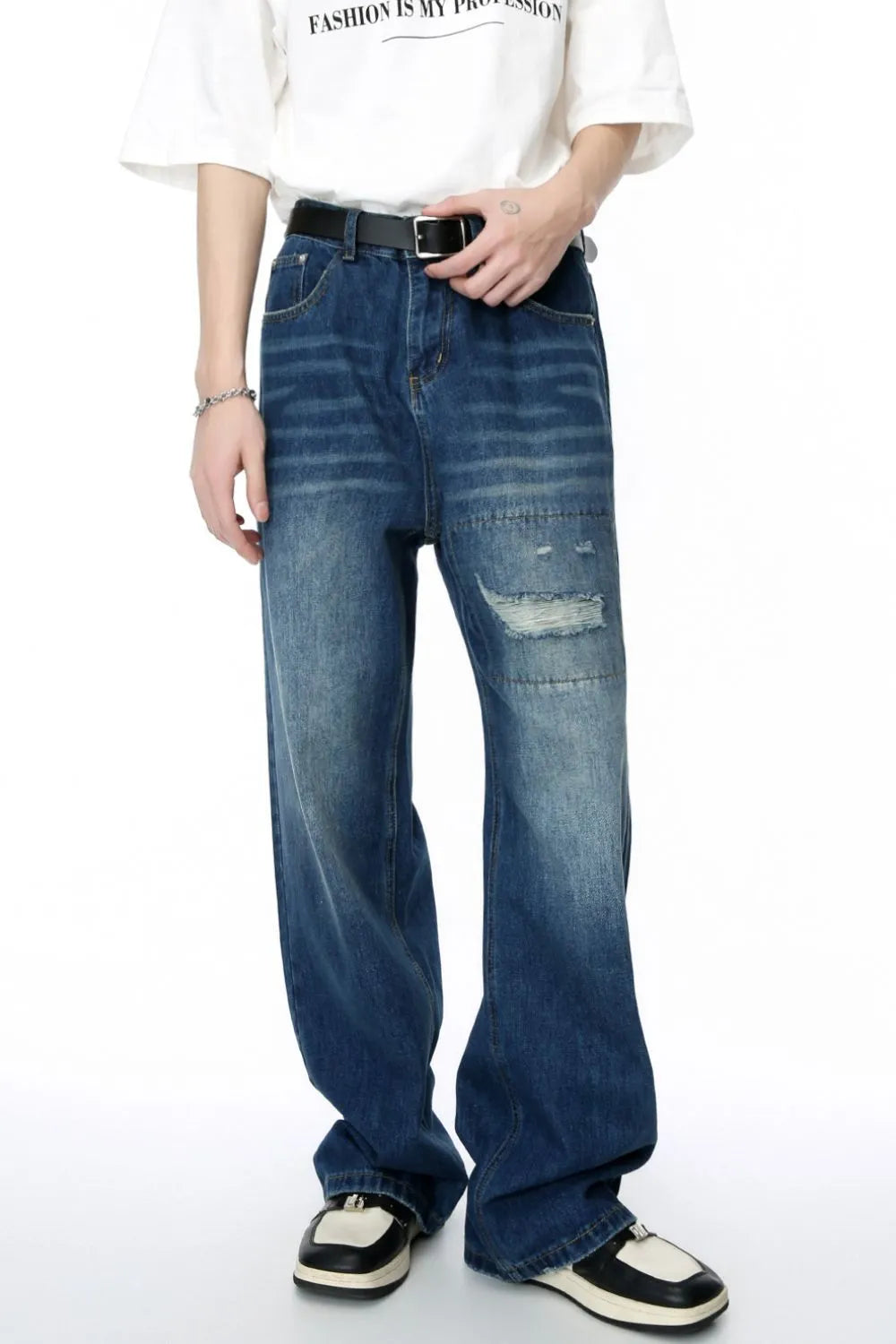 Baggy denim jeans in medium wash with patchwork and distressed details.