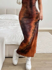 Vibrant tie-dye maxi dress in brown and black, bodycon fit, sleeveless, with white sneakers.
