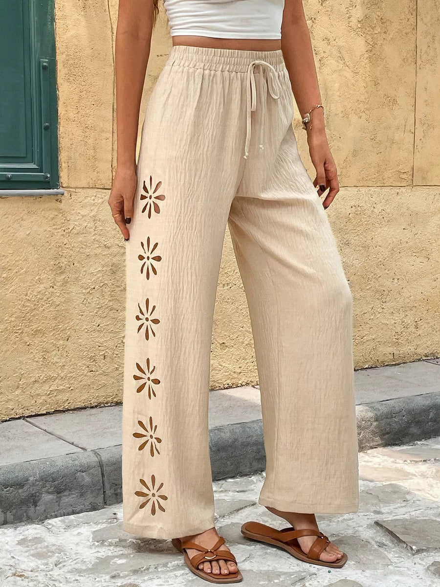 Beige linen wide-leg pants with floral cut-outs and drawstring waist