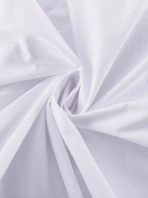 White cotton fabric with soft folds and a subtle swirl pattern