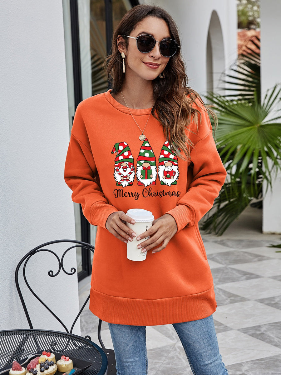 Orange tunic sweatshirt with Christmas gnomes graphic and Merry Christmas text.