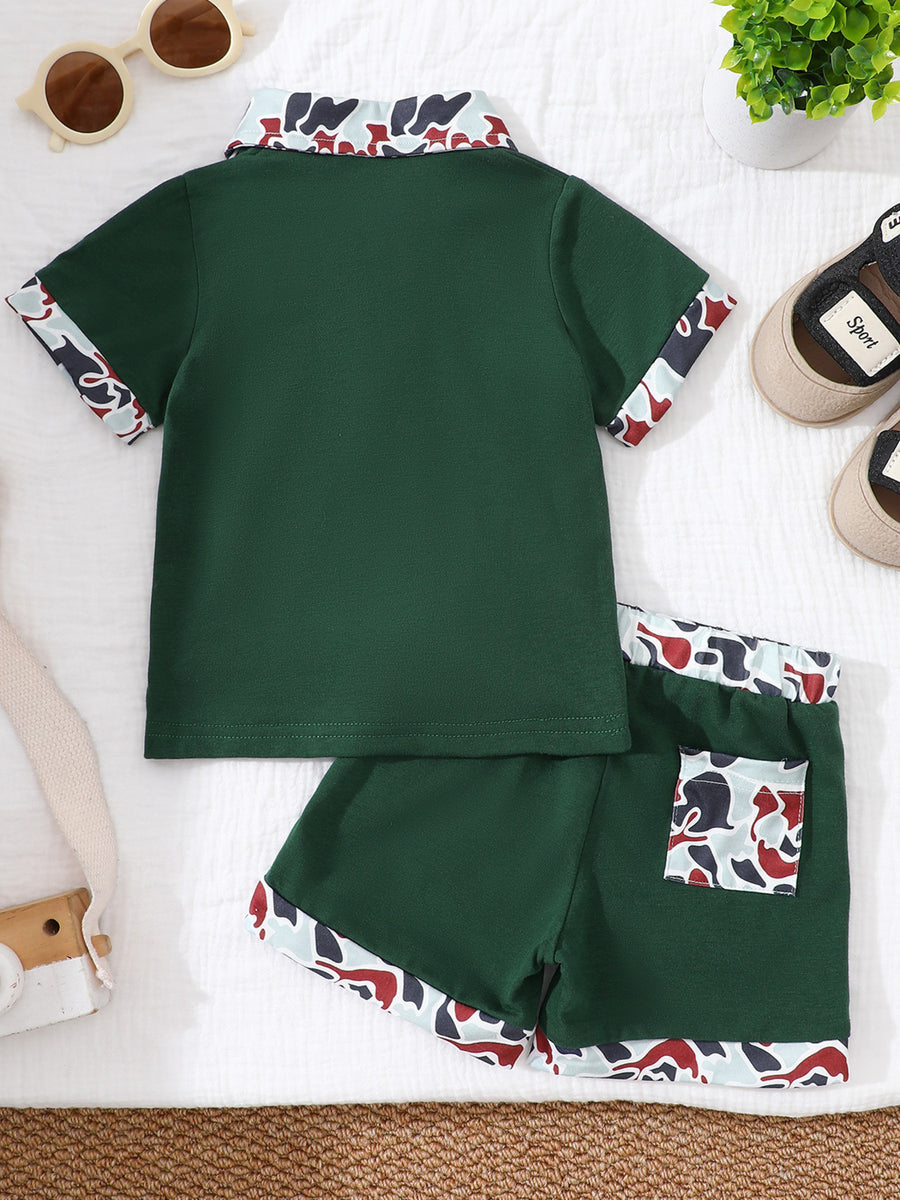 Baby polo shirt and shorts set in dark green with camouflage collar and trim.