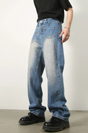Vintage wash baggy denim jeans in medium blue, featuring a relaxed fit and classic pockets.