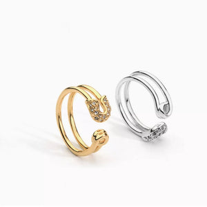 Gold and silver double band rings with zircon-embellished safety pin detail