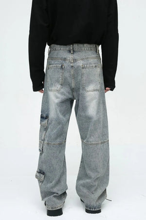 Medium wash wide leg cargo jeans with utility pockets and a relaxed fit.