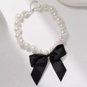 Pearl choker necklace with black bow detail