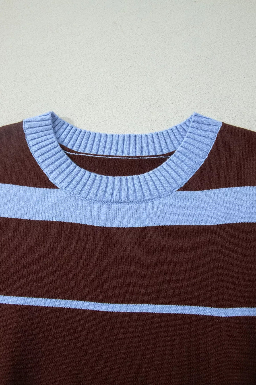 Chic striped knit sweater with crew neck and ribbed details in brown and light blue.