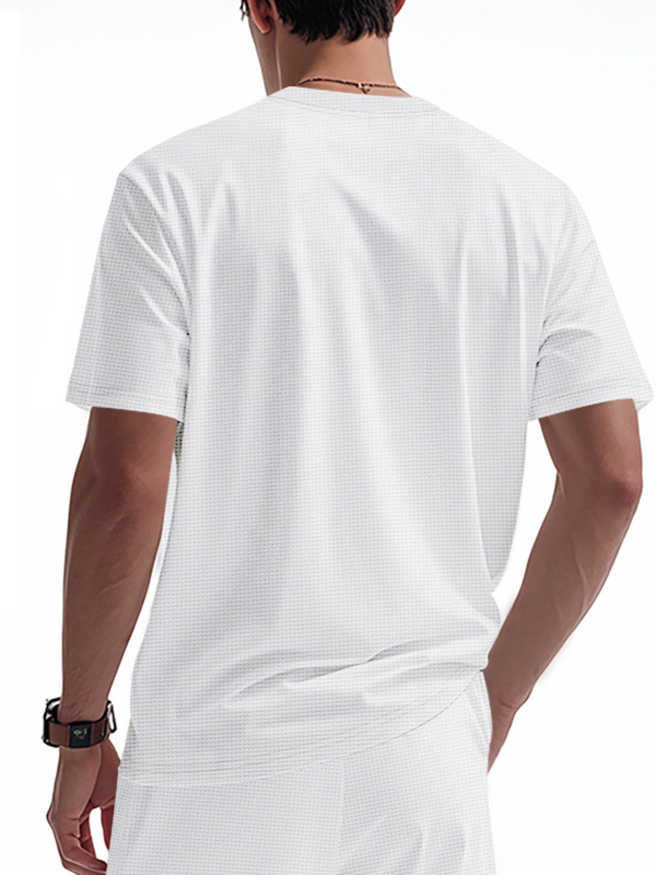 White cotton t-shirt with a subtle waffle knit texture and short sleeves.