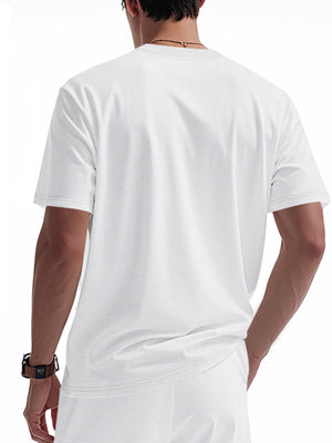White cotton t-shirt with a subtle waffle knit texture and short sleeves.