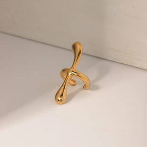 Gold ear cuff with fluid, sculptural form, 18K gold-plated.