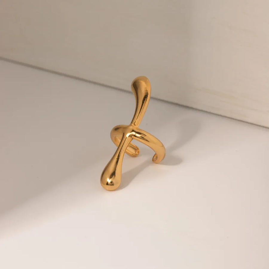 Gold ear cuff with fluid, sculptural form, 18K gold-plated.